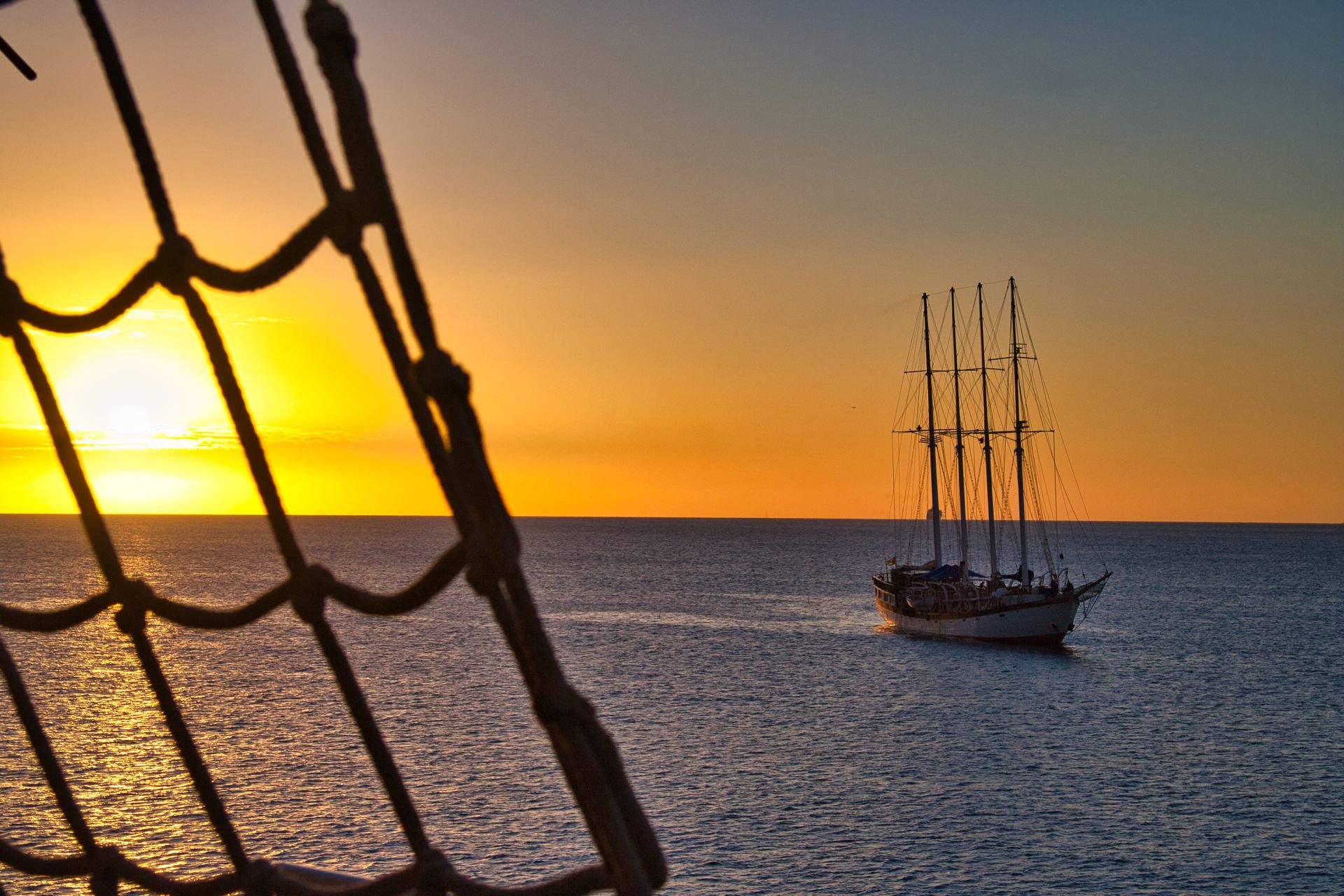 Net Rope Ladder with Three-Master Sailing Ship at Sunset